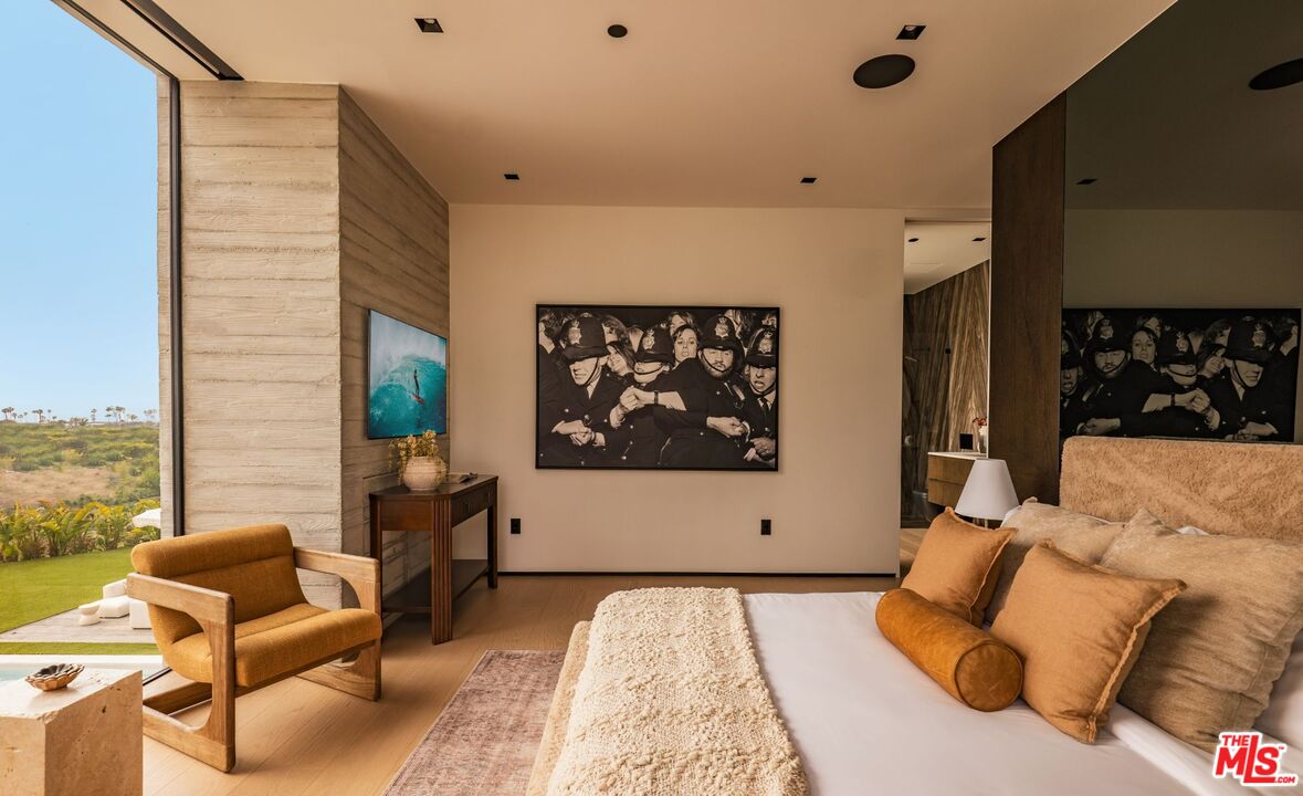 6889 Dume Drive Malibu, CA 90265 - Photo 20 of 41 a bed room with furniture and a rug