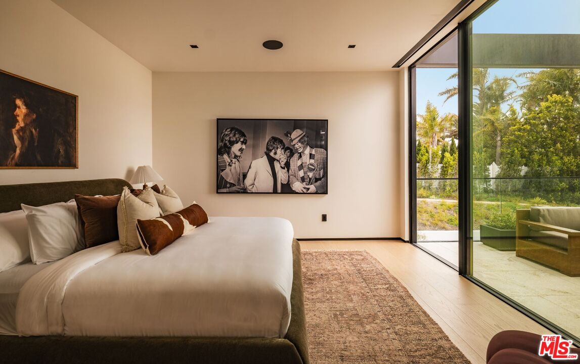 6889 Dume Drive Malibu, CA 90265 - Photo 22 of 41 a bedroom with a large bed and a large window
