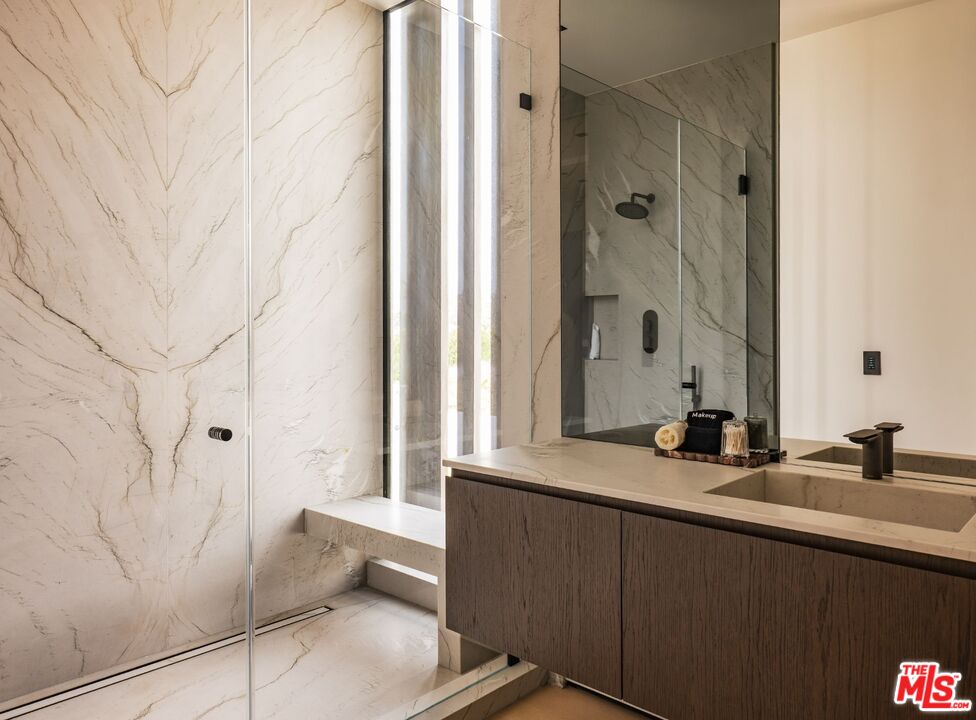6889 Dume Drive Malibu, CA 90265 - Photo 23 of 41 a bathroom with a double vanity sink and mirror