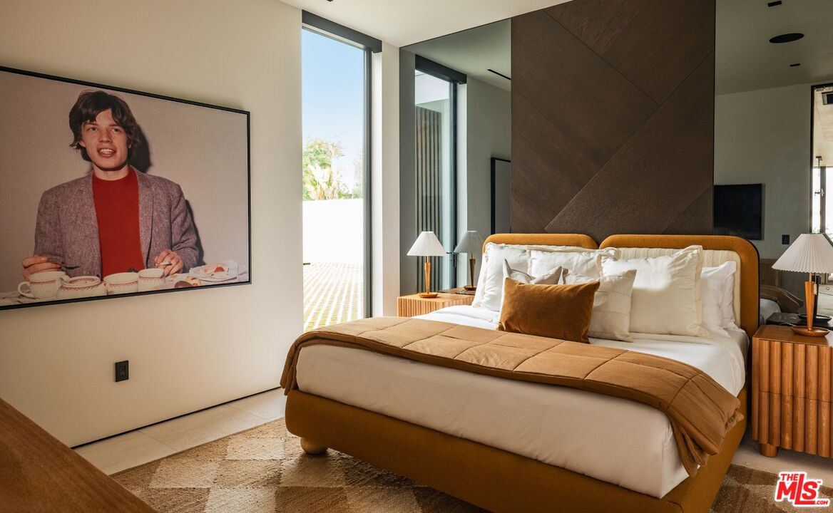 6889 Dume Drive Malibu, CA 90265 - Photo 24 of 41 a bedroom with a bed and a painting on the wall