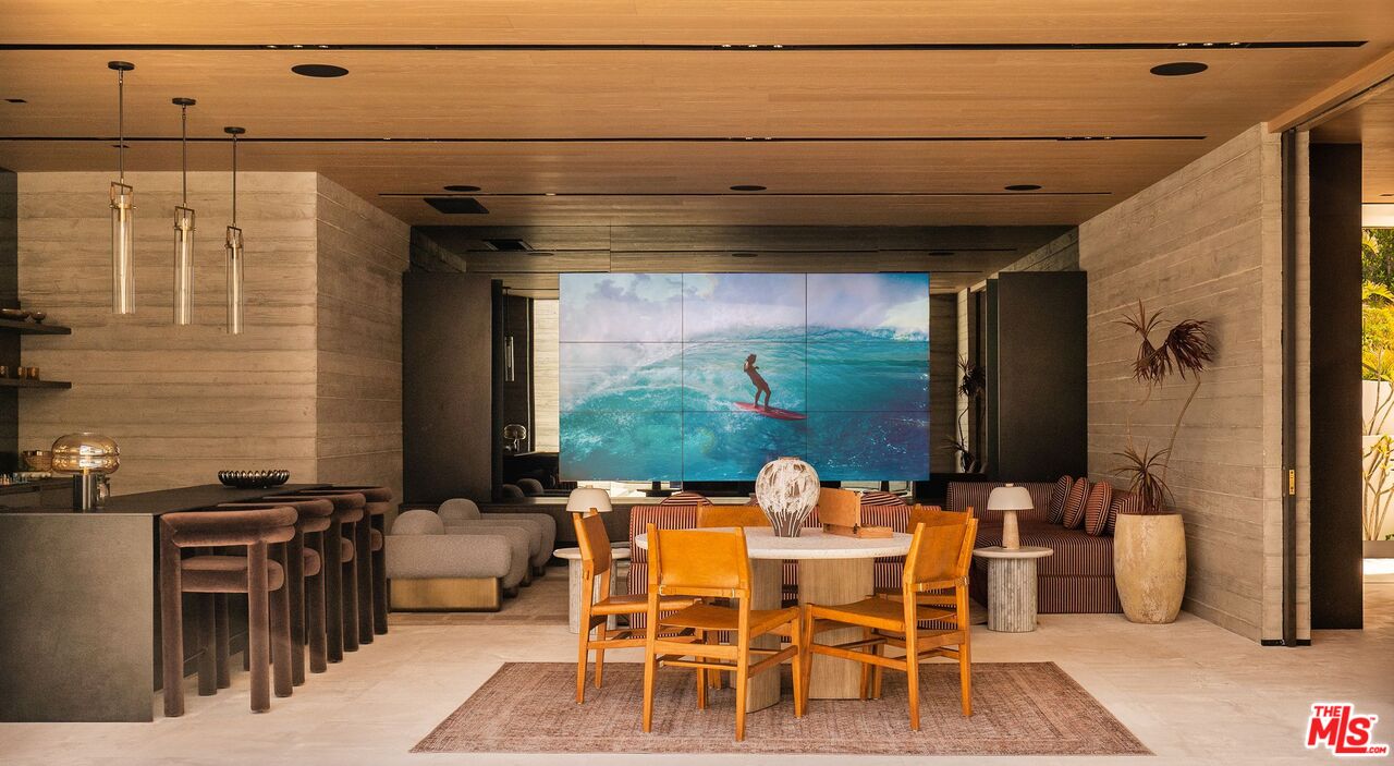 6889 Dume Drive Malibu, CA 90265 - Photo 25 of 41 a dining room with furniture and a potted plant