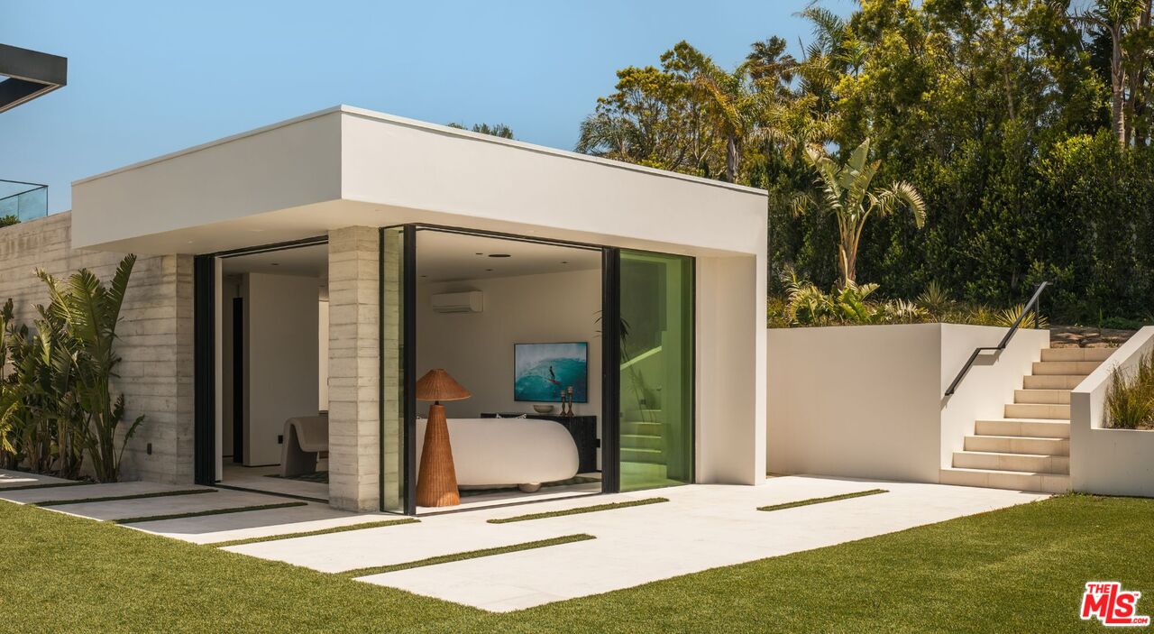 6889 Dume Drive Malibu, CA 90265 - Photo 28 of 41 a front view of a house with a garden