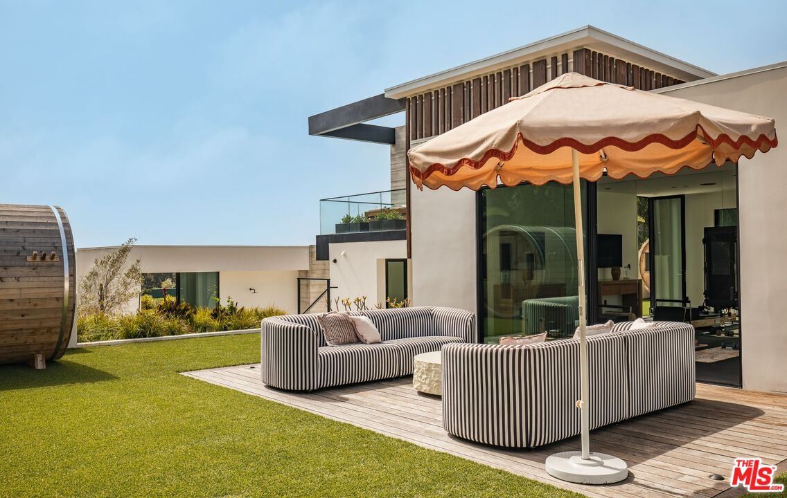 6889 Dume Drive Malibu, CA 90265 - Photo 32 of 41 a view of a patio with couches chairs and a table