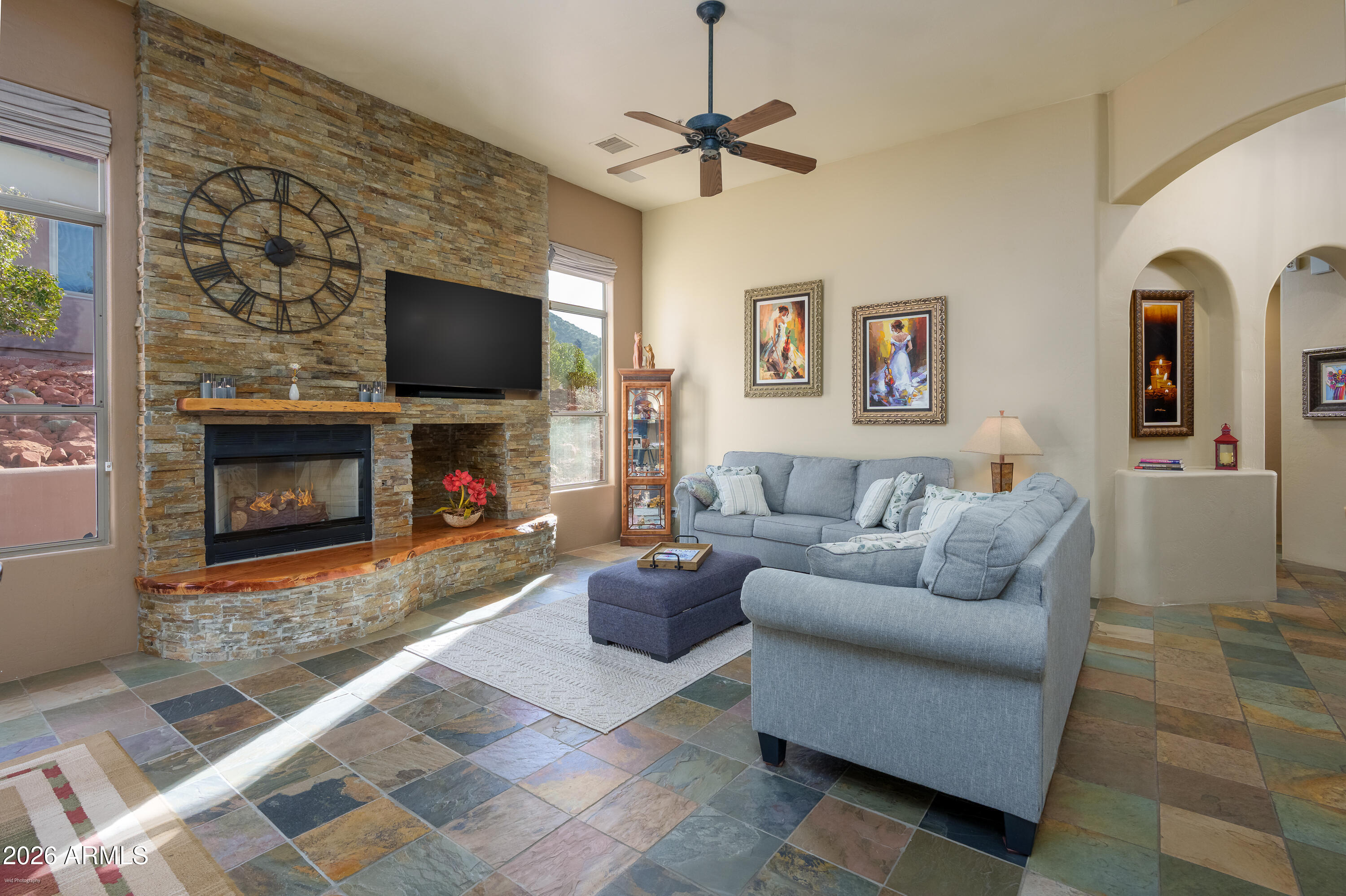 100 Rio Sinagua Sedona, AZ 86351 - Photo 11 of 43 a living room with furniture a flat screen tv and a fireplace