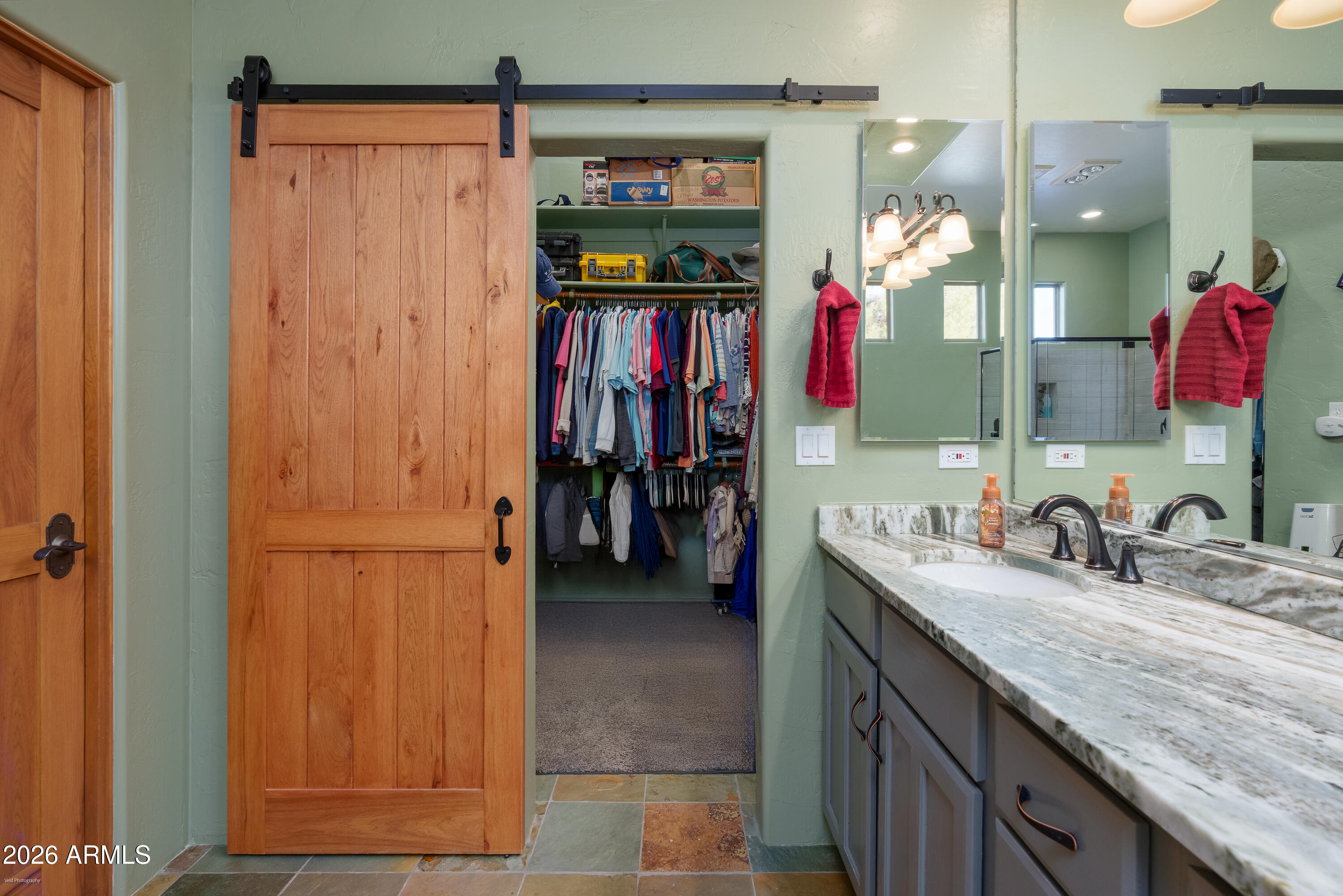 100 Rio Sinagua Sedona, AZ 86351 - Photo 26 of 43 a bathroom with a granite countertop sink a mirror and a shower