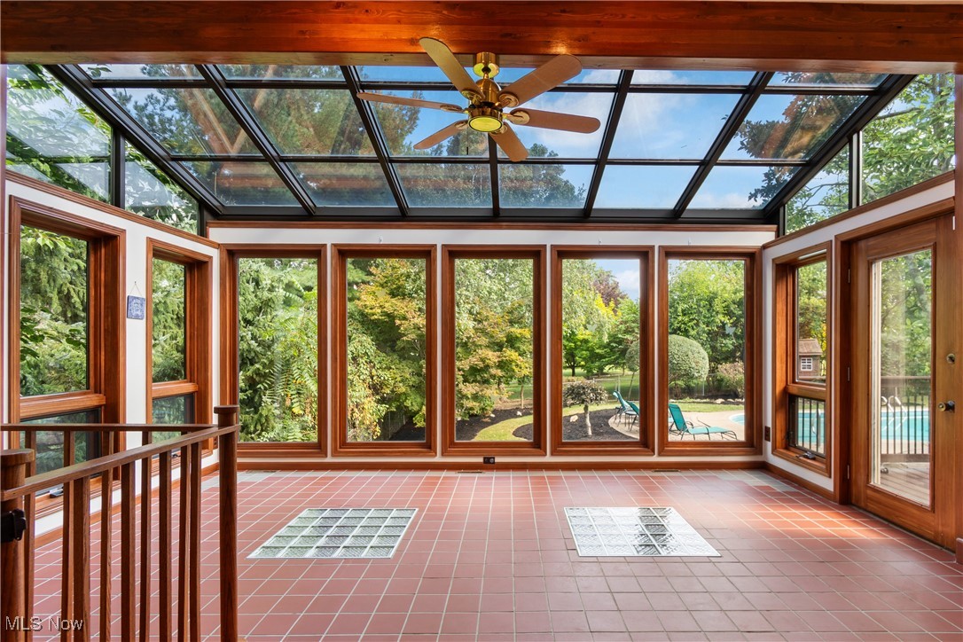 2317 Raintree Street Northeast Canton, OH 44705 - Photo 10 of 40 Unfurnished sunroom featuring tile patterned floors and vaulted ceiling