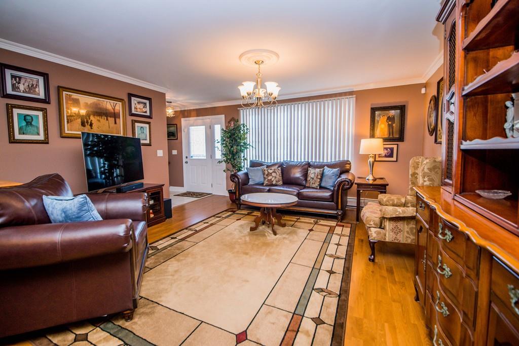 1461 Rodman Street Fall River, MA 02721 - Photo 14 of 40 a living room with furniture a fireplace and a flat screen tv