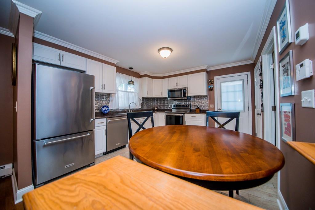 1461 Rodman Street Fall River, MA 02721 - Photo 21 of 40 a view of a kitchen with refrigerator and wooden floor