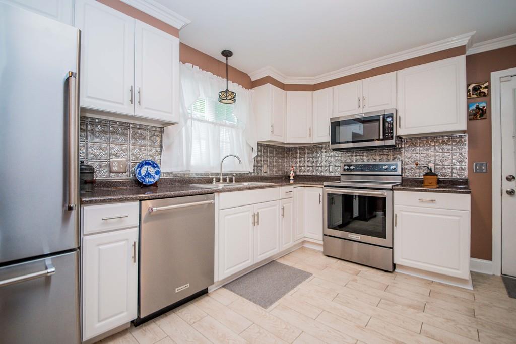 1461 Rodman Street Fall River, MA 02721 - Photo 22 of 40 a kitchen with cabinets stainless steel appliances and sink