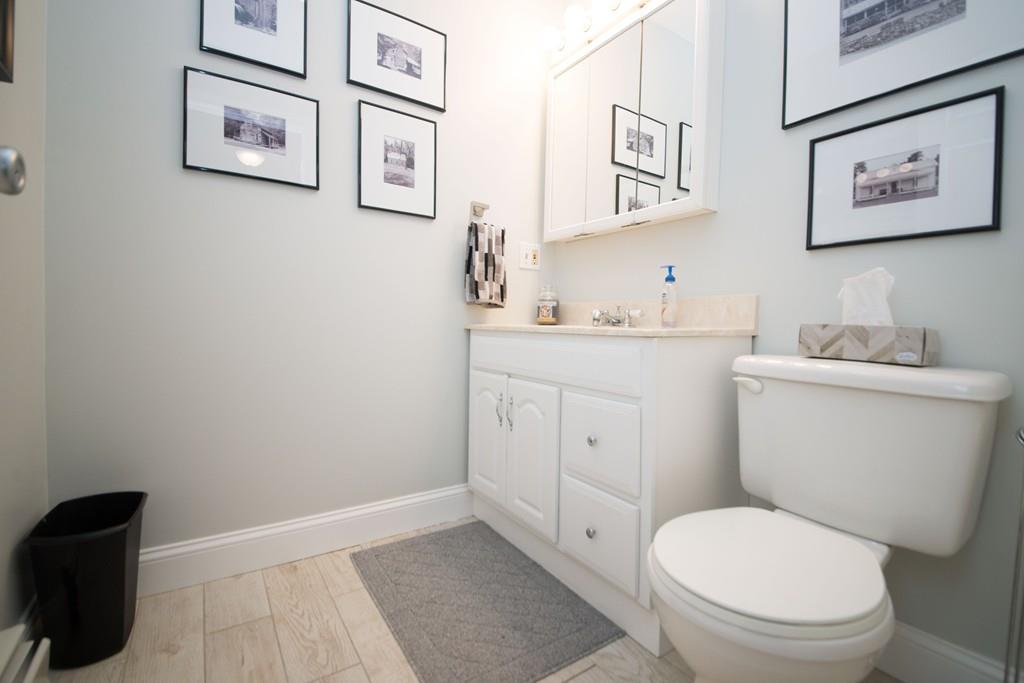1461 Rodman Street Fall River, MA 02721 - Photo 26 of 40 a white toilet sitting next to a bathroom sink