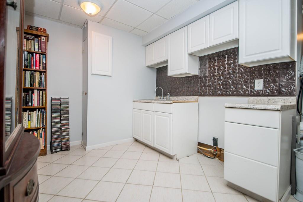 1461 Rodman Street Fall River, MA 02721 - Photo 38 of 40 a kitchen with a stove and cabinets