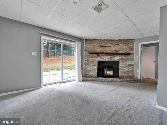 an empty room with furniture and a fireplace