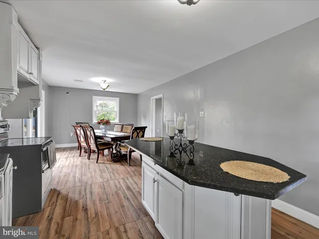 a kitchen with sink and view of living room