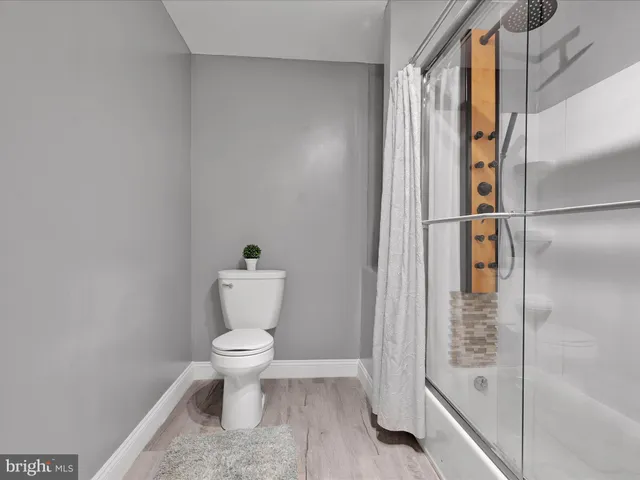 a bathroom with a toilet and a shower