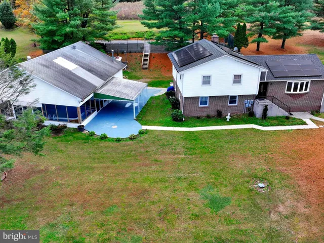 an aerial view of residential houses with yard