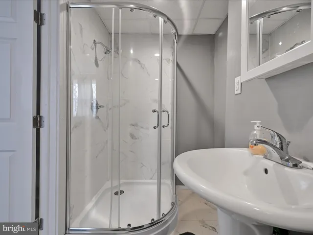 a bathroom with a sink and shower