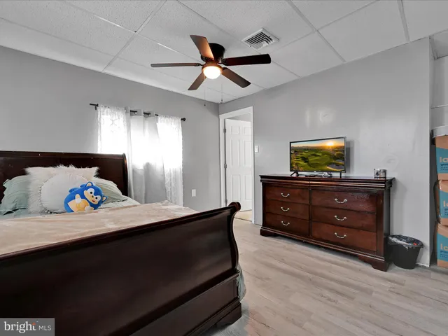 a bed room with a bed and a ceiling fan
