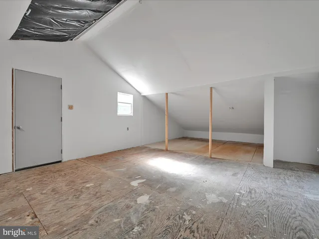 a view of a livingroom with stairs and a couch