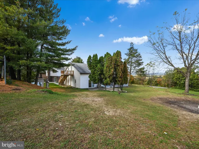 a front view of house with yard and trees