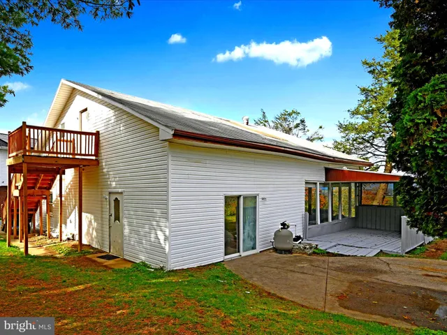 a view of a house with garden and trees