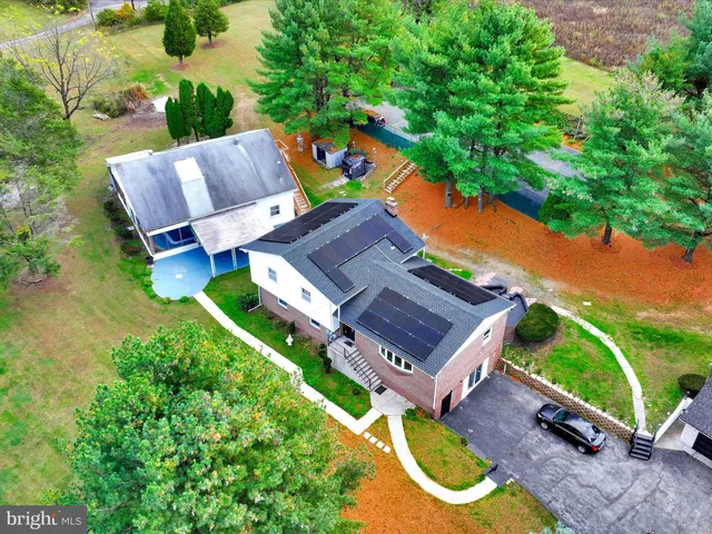 an aerial view of a house with a garden and swimming pool