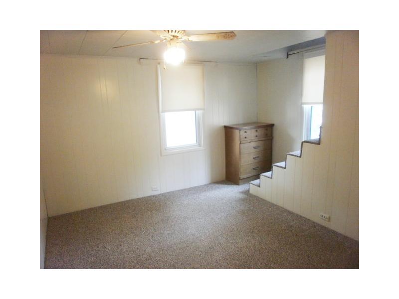 198 Mahle Road Clarksville, PA 15322 - Photo 12 of 22 Bedroom. Second Bedroom with paddle fan and nice neutral wall to wall carpeting as throughout. This bedroom also has the open stairway to the upper level den/playroom/storage area or even a possible third bedroom.