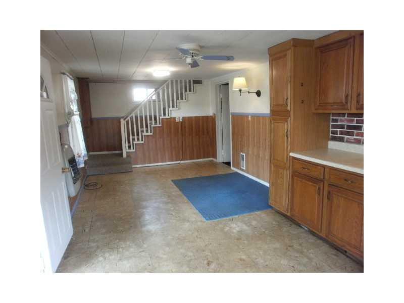 198 Mahle Road Clarksville, PA 15322 - Photo 5 of 22 Dining Room. View of the Dining area from the kitchen with paddle fan and stairway to upper level.
