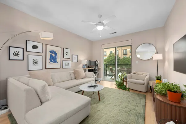 a living room with furniture and a large window