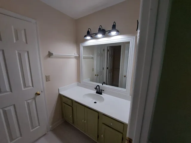a bathroom with double sink and mirror