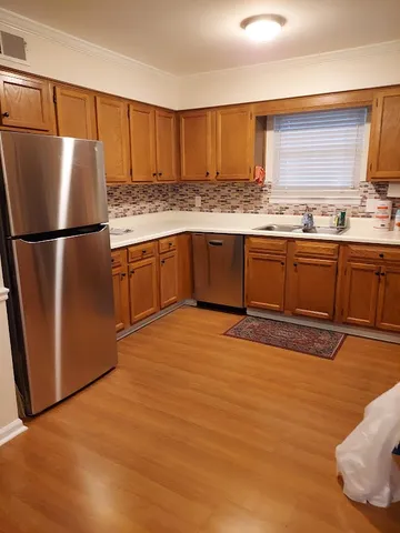 a kitchen with stainless steel appliances granite countertop a refrigerator sink and cabinets