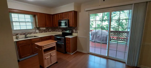 a kitchen with stainless steel appliances granite countertop a stove a sink and a refrigerator