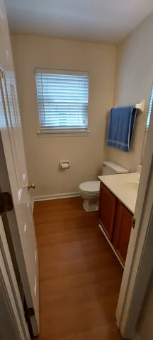 a bathroom with a sink a toilet and a window