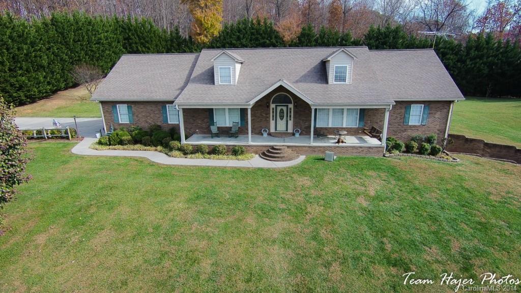7858 Cheatham Ford Road Hiddenite, NC 28636 - Photo 1 of 24 a front view of house with yard and green space
