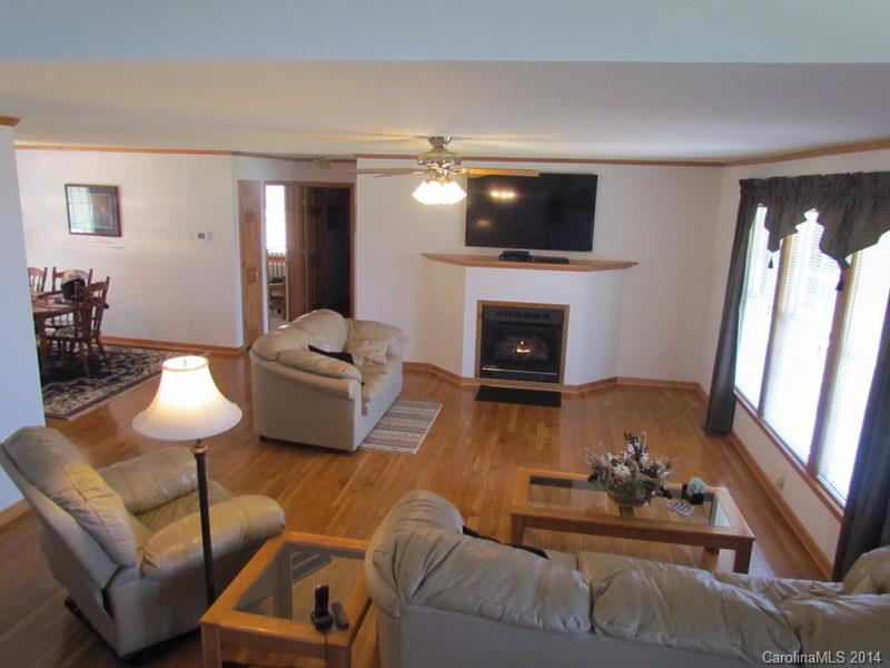 7858 Cheatham Ford Road Hiddenite, NC 28636 - Photo 11 of 24 a living room with furniture fireplace and a flat screen tv