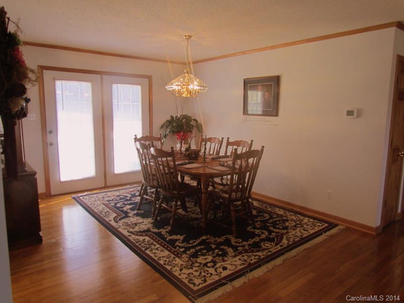 7858 Cheatham Ford Road Hiddenite, NC 28636 - Photo 12 of 24 a view of a dining room with furniture and wooden floor