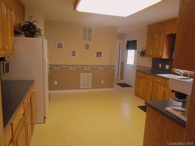 7858 Cheatham Ford Road Hiddenite, NC 28636 - Photo 14 of 24 a view of a kitchen with a refrigerator