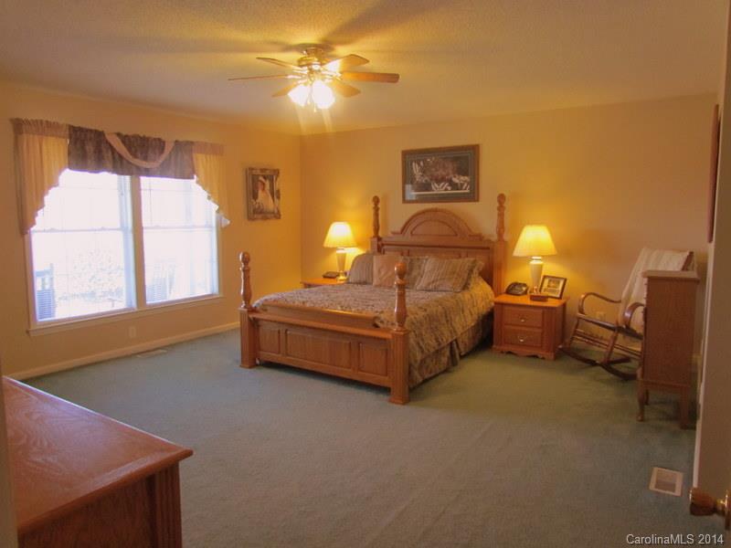 7858 Cheatham Ford Road Hiddenite, NC 28636 - Photo 16 of 24 a bedroom with furniture and a window