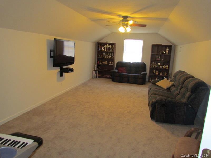 7858 Cheatham Ford Road Hiddenite, NC 28636 - Photo 17 of 24 a living room with furniture and a flat screen tv