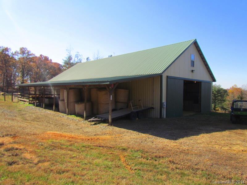7858 Cheatham Ford Road Hiddenite, NC 28636 - Photo 9 of 24 a front view of a house with a yard and garage