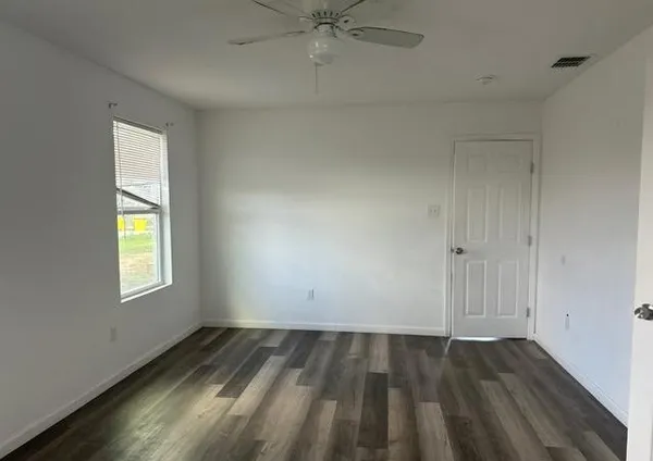 wooden floor in an empty room with a window