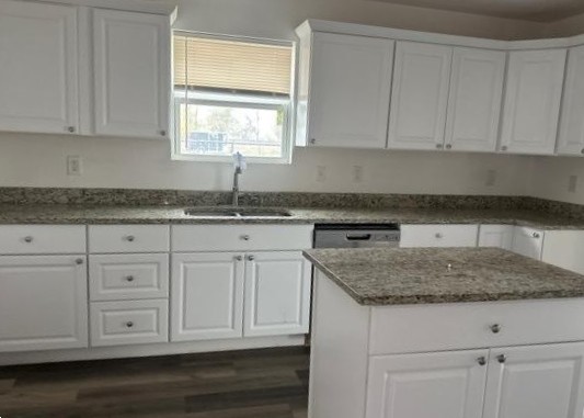 2519 County Road 5710 Devine, TX 78016 - Photo 14 of 18 a kitchen with granite countertop white cabinets and a sink