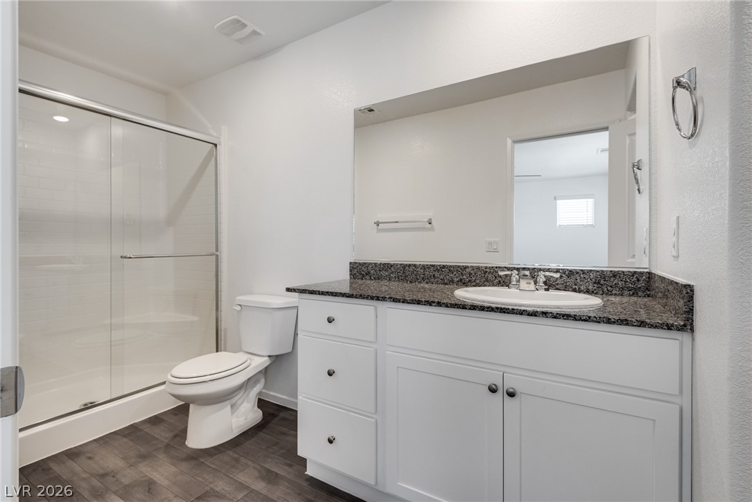 1114 Scarlet Sparrow Street Henderson, NV 89011 - Photo 17 of 25 A well-appointed bathroom with a spacious vanity and a walk-in shower.