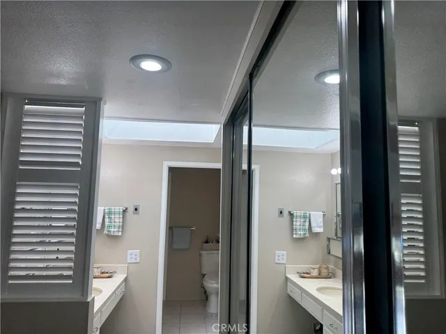 a bathroom with a glass door shower and a sink