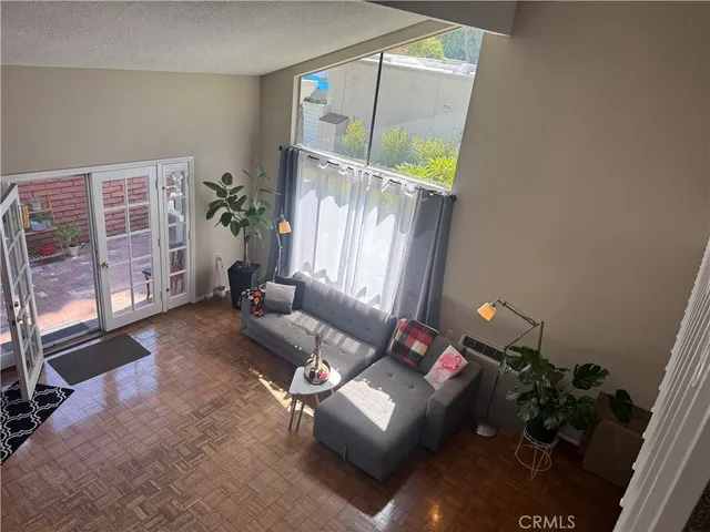 a living room with furniture windows and a potted plant