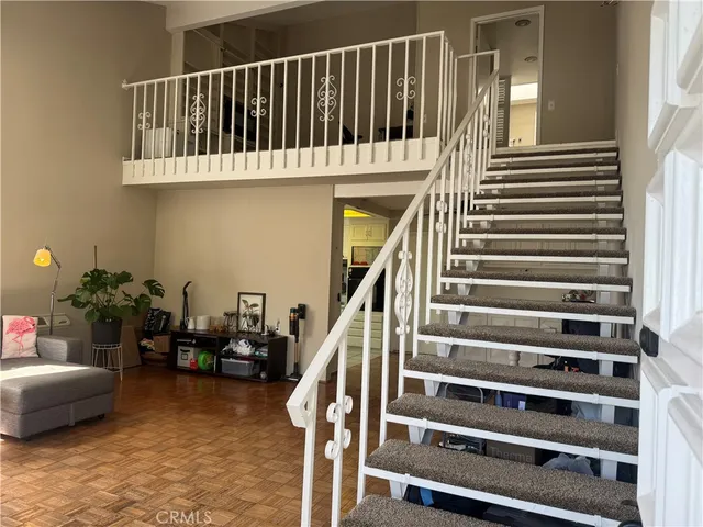 a view of staircase with lots of wooden floor and a potted plant