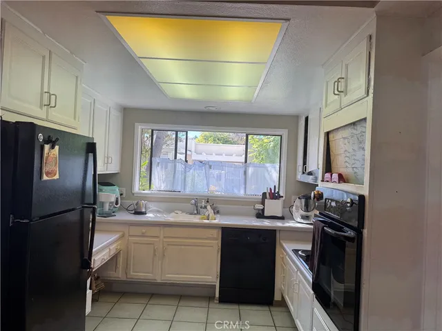 a kitchen with a sink appliances and cabinets