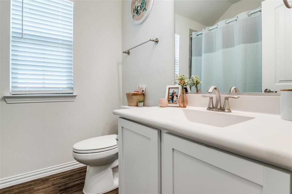 14845 Gilley Lane Fort Worth, TX 76052 - Photo 11 of 35 a bathroom with a sink and a toilet