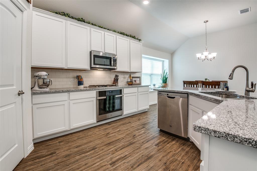 14845 Gilley Lane Fort Worth, TX 76052 - Photo 21 of 35 a kitchen with stainless steel appliances granite countertop a sink dishwasher a stove and a microwave oven with cabinets