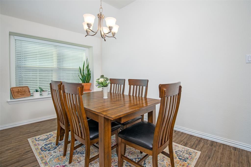 14845 Gilley Lane Fort Worth, TX 76052 - Photo 25 of 35 a view of a dining room with furniture wooden floor and chandelier