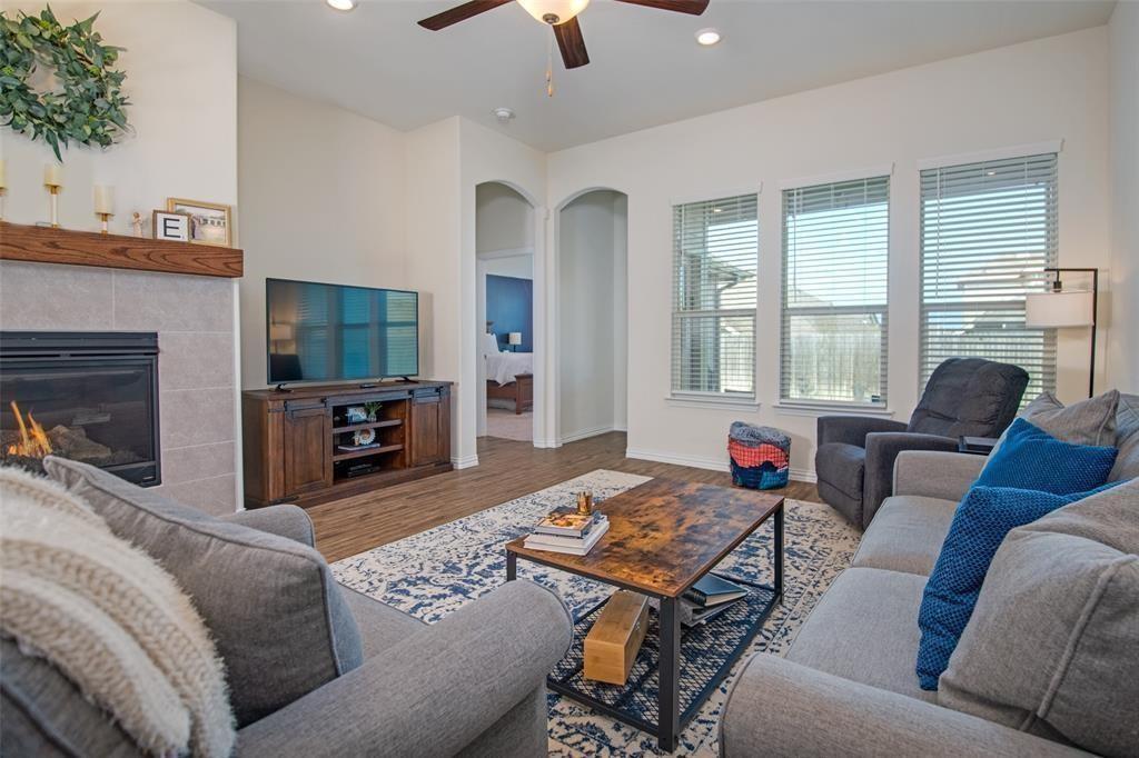 14845 Gilley Lane Fort Worth, TX 76052 - Photo 26 of 35 a living room with furniture a fireplace and a flat screen tv